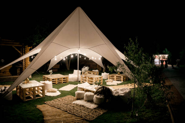 Spacious tent in the garden for a wedding party.